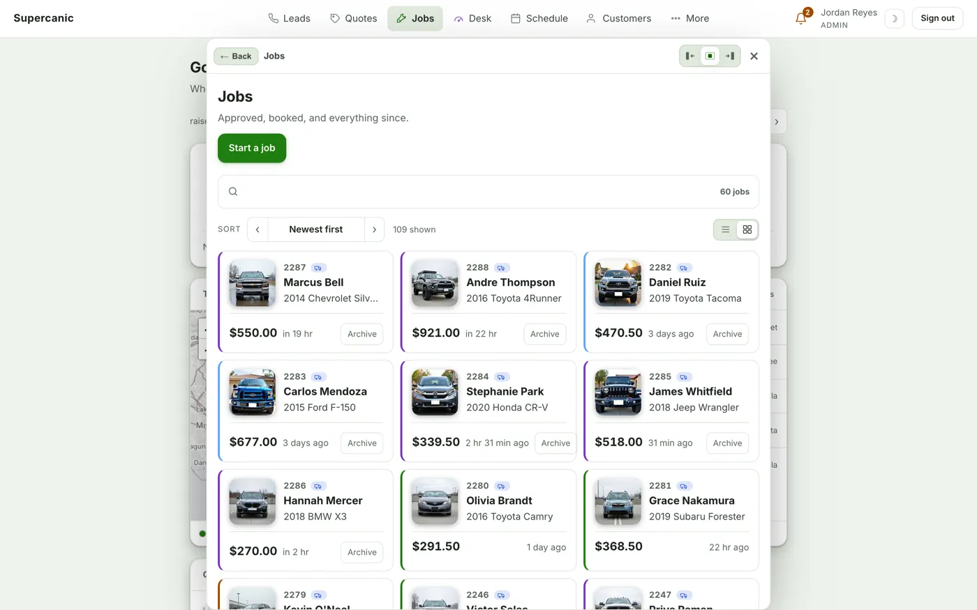 Shop Desk jobs on a laptop as tiles, each with a photo of the car